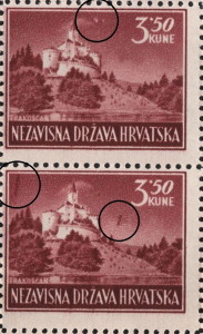 Two spots in the sky above the castle, close to the upper frame (the upper stamp)