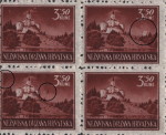 White spots above the pine forest on the right (the second stamp)