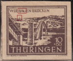 Germany Thueringen post stamp flaw: Residue between letters A and U in BAUEN and a tree on the horizon above the first pillar.
