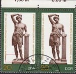 GDR 1983 Amazon statue postage stamp plate flaw Long thin line crossing Amazon’s ankles. 