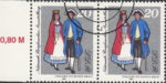 GDR 1984 National Stamp Exhibition postage stamp plate flaw Thin blue line on woman’s dress below belt.