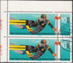 GDR 1985 Diving Championship postage stamp plate flaw Line of diver’s fin continuing to the yellow area.