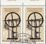 GDR 1985 Steam Engine postage stamp plate flaw Horizontal line on the element holding the wheel thinner on the right side.